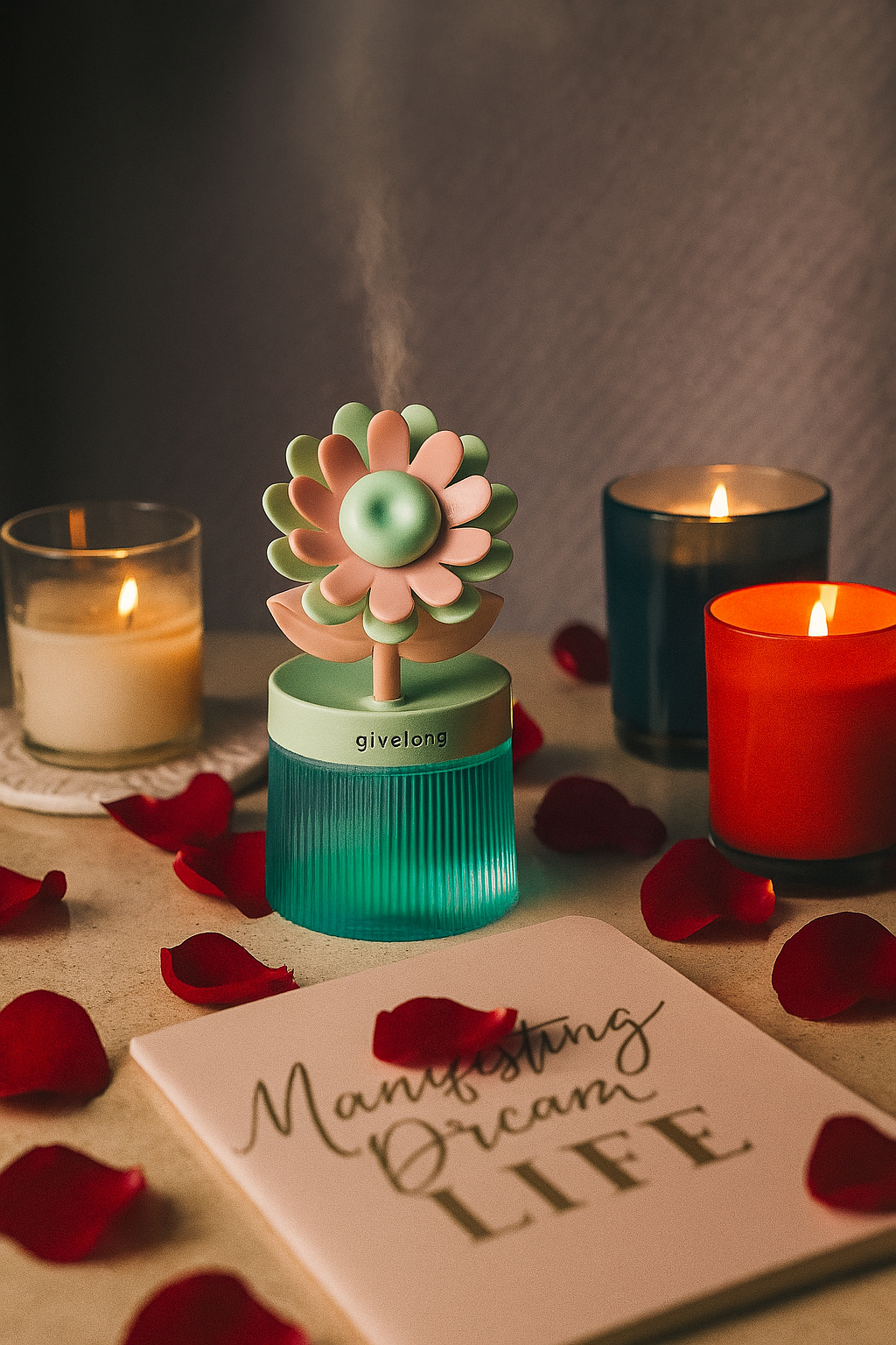 Decorative diffuser with flowers, candles, and a motivational card on a table.